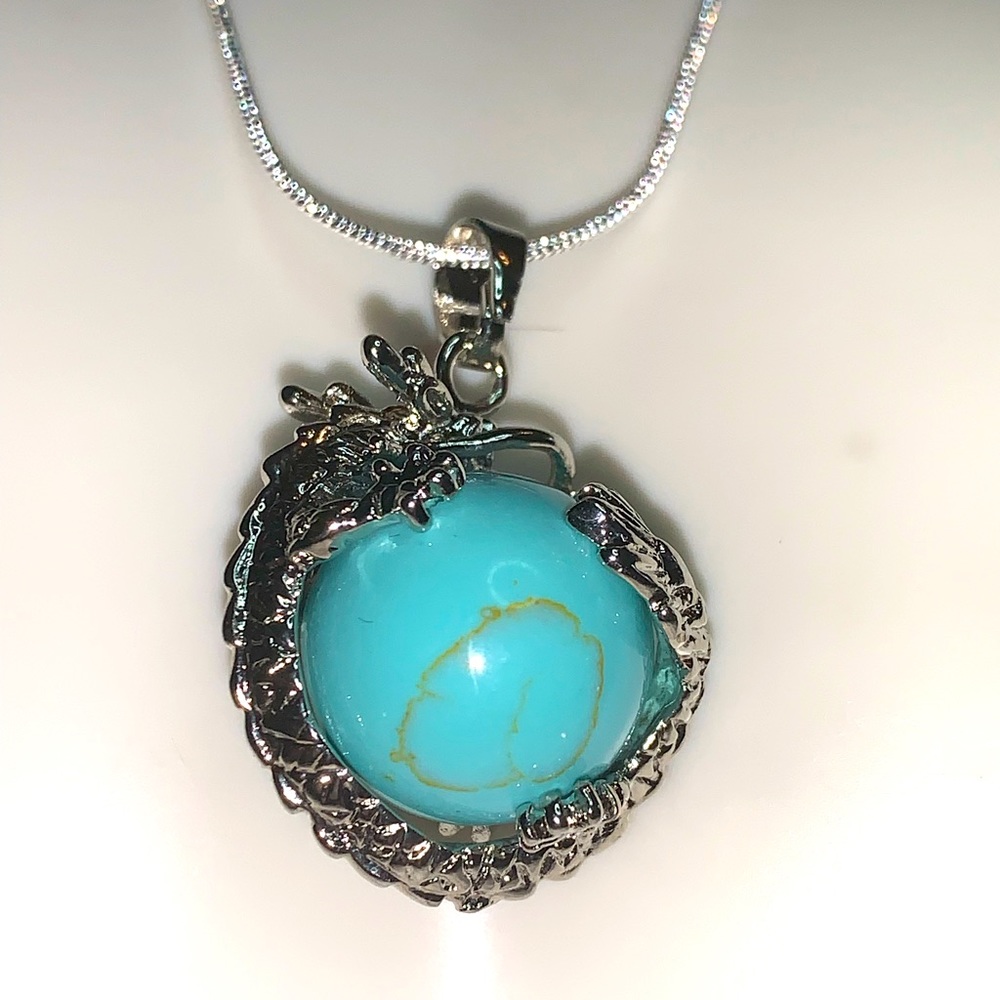 Turquoise dragon ball in a chain necklace.
